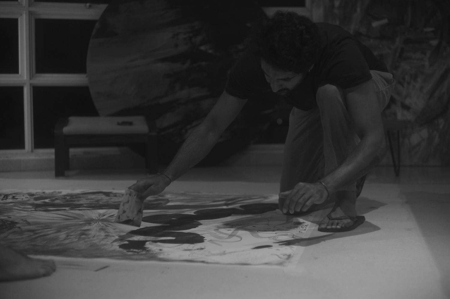 A figure drawing a squeegee across the wet surface