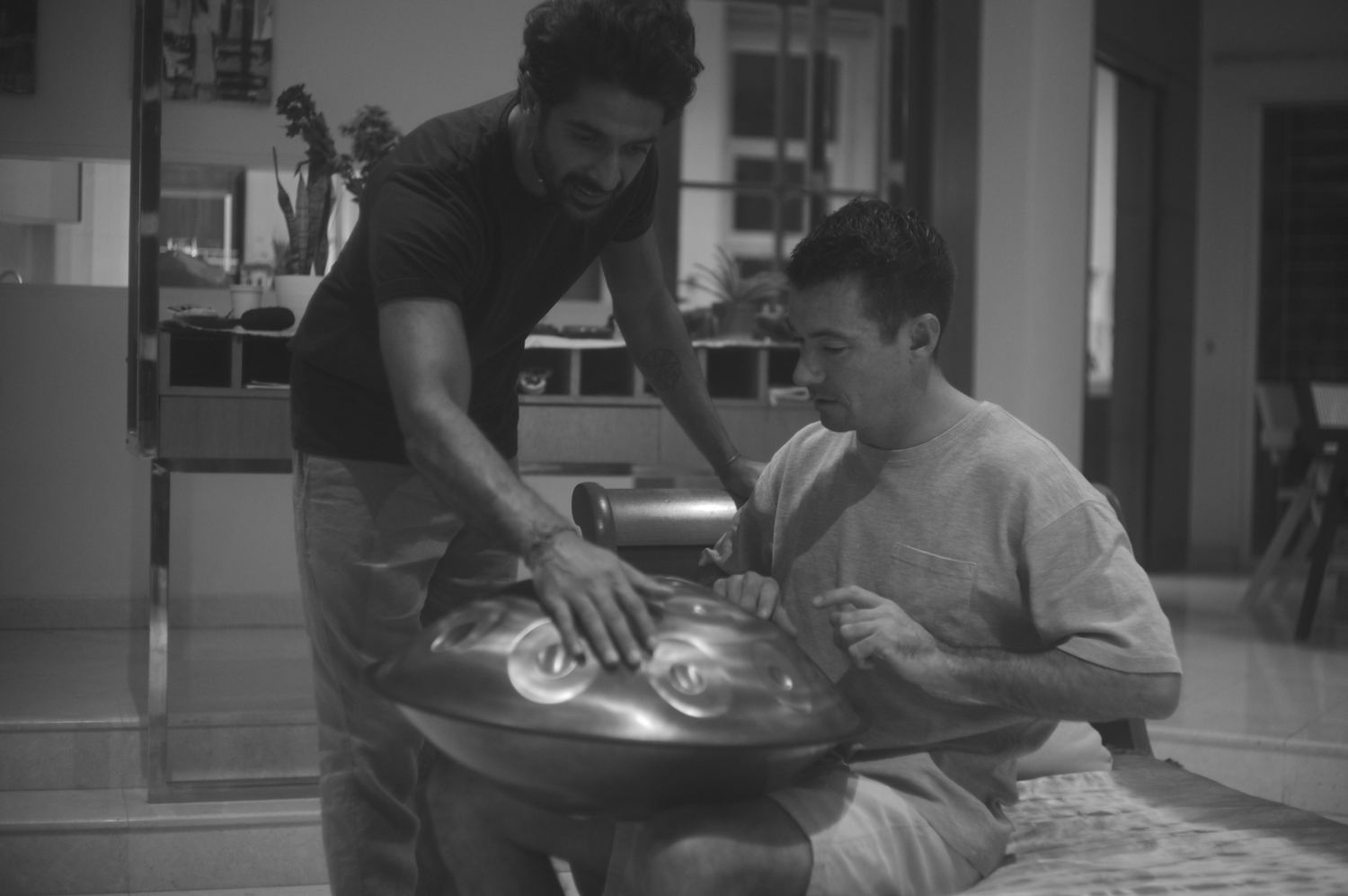 Two players sharing a handpan