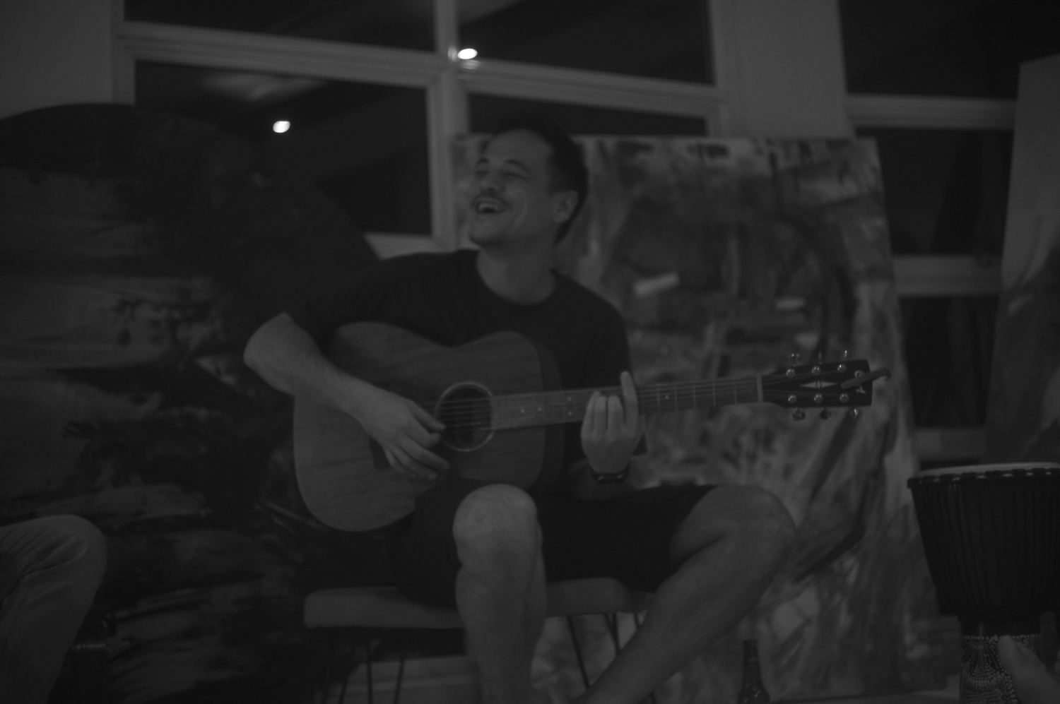 A guitarist playing while others listen